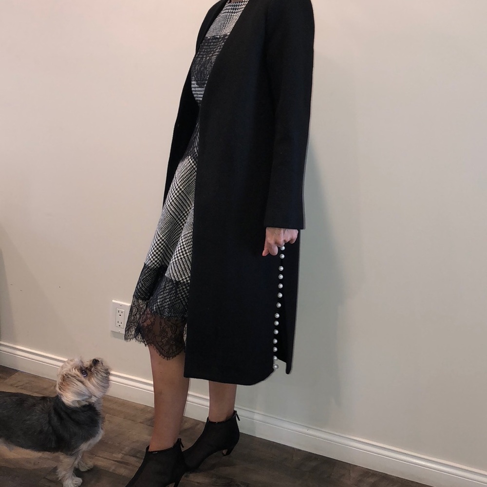 Black coat with faux pearl buttons.